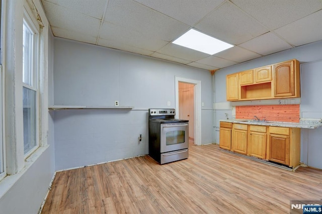kitchen featuring light wood-style flooring, a sink, a drop ceiling, electric range, and open shelves