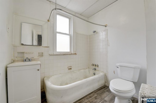 bathroom featuring bathtub / shower combination, wood finished floors, vanity, and toilet