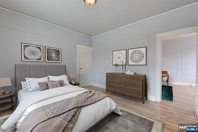 bedroom with wood finished floors and baseboards