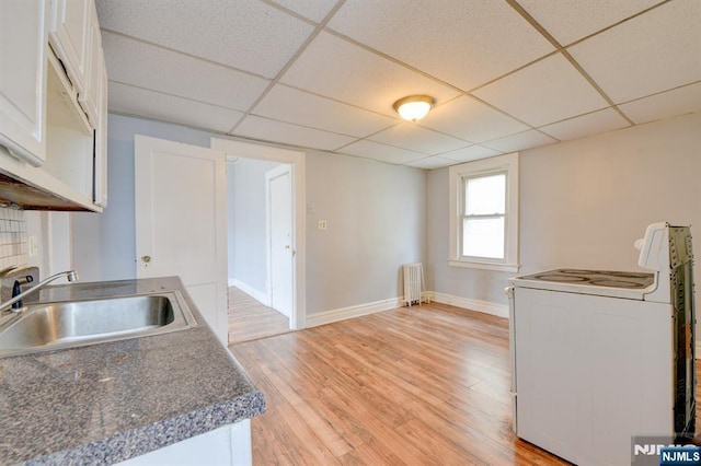 kitchen featuring radiator heating unit, a sink, white range with electric stovetop, and a drop ceiling
