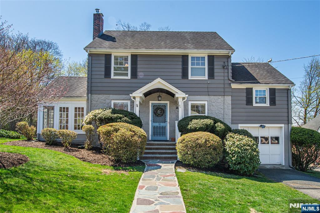 12 Harding Rd, West Caldwell, NJ 07006 - view of front facade with a garage, roof with shingles, a front lawn, and a chimney