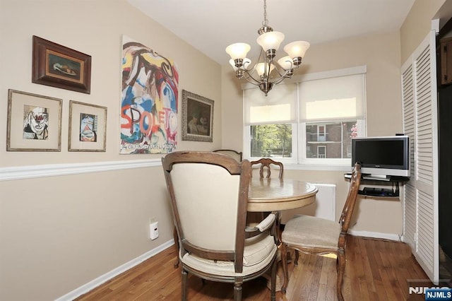 311 Grand Ave Unit 23, Englewood, NJ 07631 - dining room featuring hardwood / wood-style floors, a chandelier, and baseboards