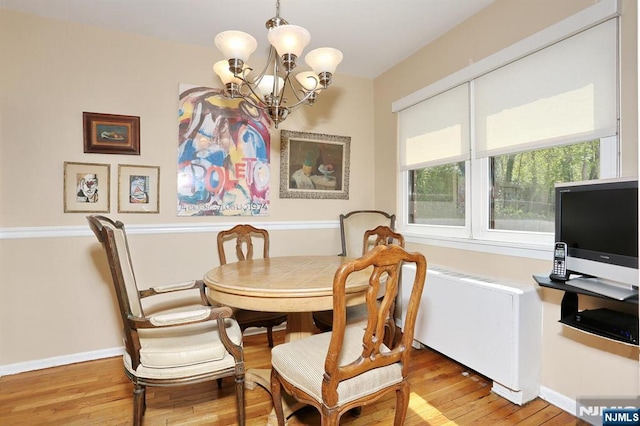 311 Grand Ave Unit 23, Englewood, NJ 07631 - dining area featuring baseboards, a notable chandelier, and light wood-style flooring