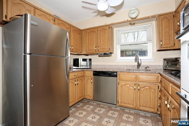 311 Grand Ave Unit 23, Englewood, NJ 07631 - kitchen featuring a sink, stainless steel appliances, ceiling fan, light stone counters, and light floors