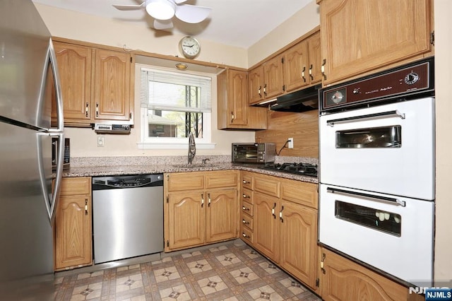 311 Grand Ave Unit 23, Englewood, NJ 07631 - kitchen with light stone countertops, light floors, stainless steel appliances, ceiling fan, and a sink