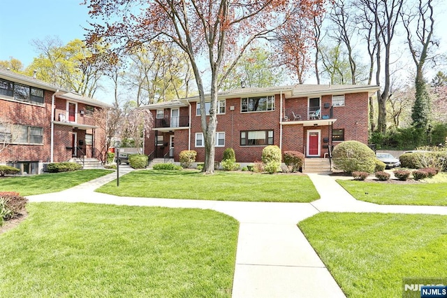 311 Grand Ave Unit 23, Englewood, NJ 07631 - view of front of home featuring a front yard, a balcony, and brick siding