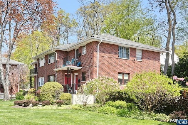 311 Grand Ave Unit 23, Englewood, NJ 07631 - view of front of home featuring brick siding, a front lawn, and a balcony