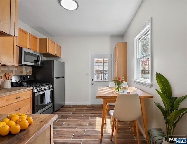 85 Anderson Ave, Wallington, NJ 07057 - kitchen with stainless steel appliances, dark wood-style flooring, backsplash, light brown cabinetry, and baseboards