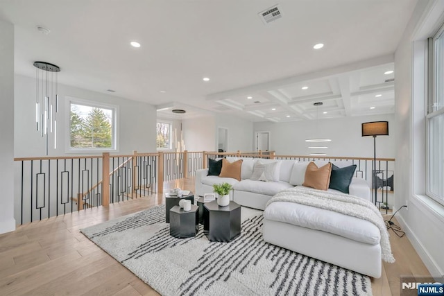 living area featuring recessed lighting, coffered ceiling, wood finished floors, visible vents, and beamed ceiling