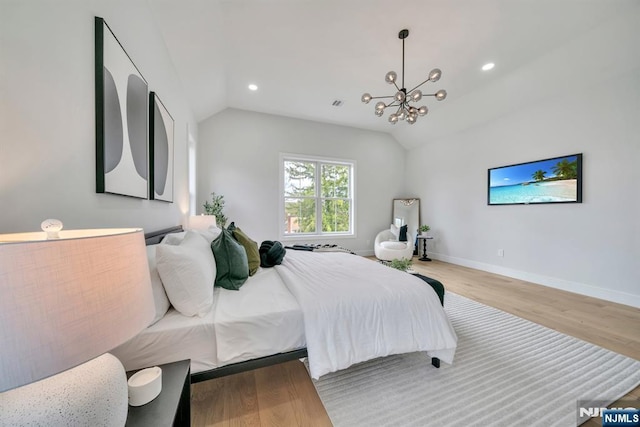 bedroom with vaulted ceiling, wood finished floors, an inviting chandelier, and recessed lighting