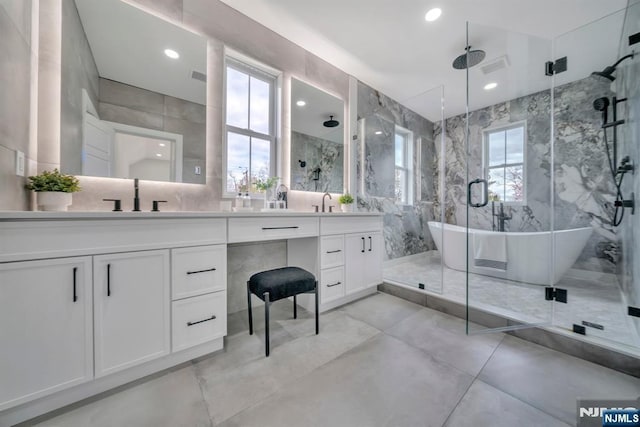 full bath with a sink, finished concrete floors, double vanity, and a stall shower