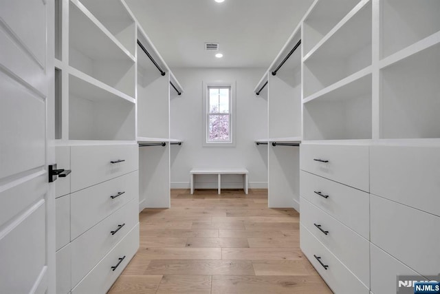 spacious closet featuring visible vents and light wood-type flooring