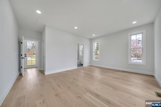 interior space with recessed lighting, baseboards, light wood-style flooring, and plenty of natural light