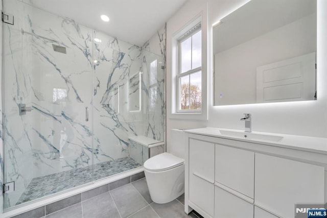 bathroom featuring a marble finish shower, recessed lighting, vanity, and toilet