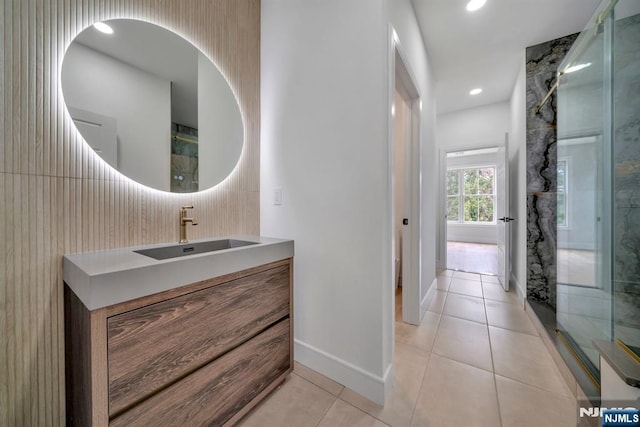 full bath with tile patterned floors, baseboards, recessed lighting, walk in shower, and vanity