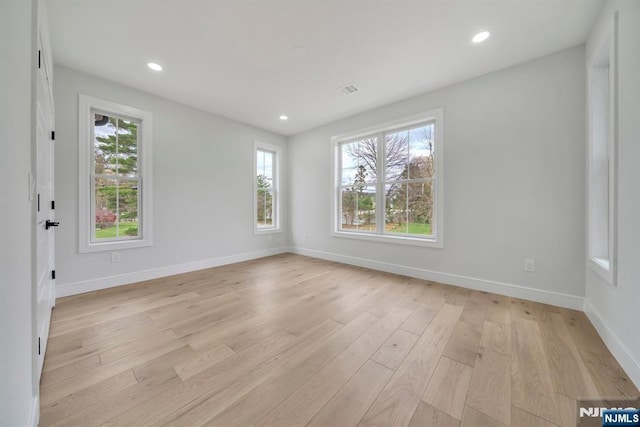 spare room with light wood-style flooring, baseboards, and recessed lighting