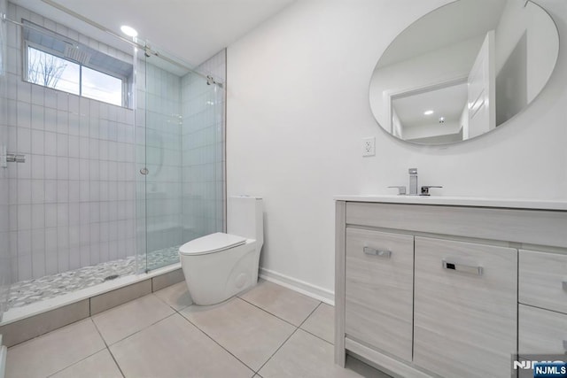 bathroom with vanity, tile patterned flooring, a shower stall, and toilet