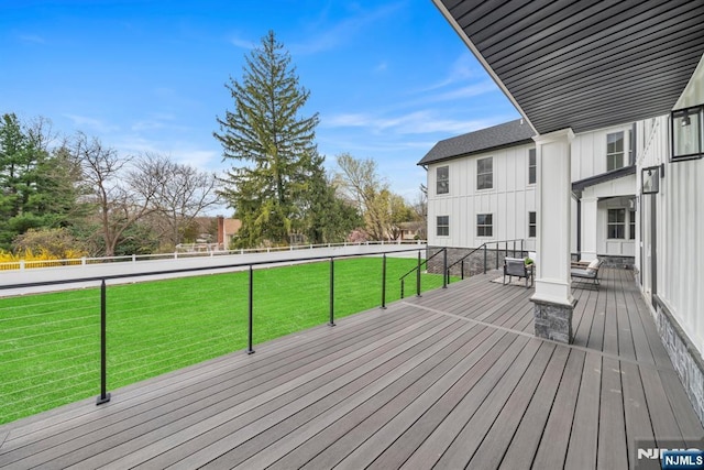 wooden deck featuring a yard