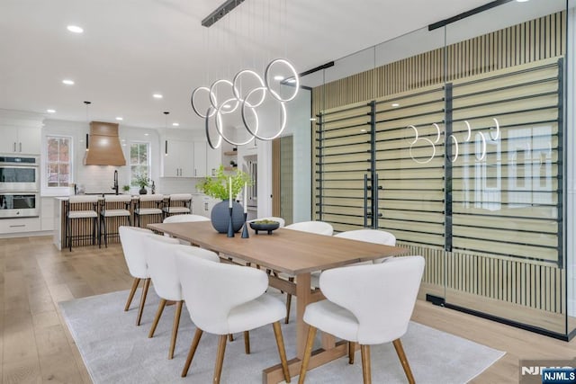 dining space with recessed lighting and light wood-type flooring