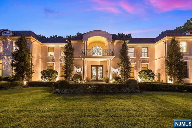 354 Hardenburgh Ave, Demarest, NJ 07627 - mediterranean / spanish-style home featuring a balcony, french doors, a front yard, and stucco siding