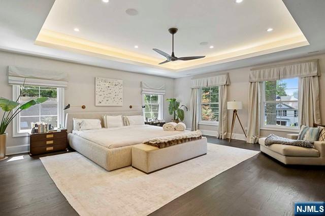 354 Hardenburgh Ave, Demarest, NJ 07627 - bedroom with a tray ceiling, dark wood-style flooring, recessed lighting, and baseboards