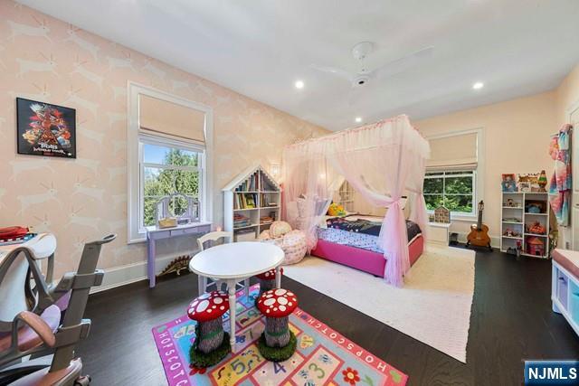 354 Hardenburgh Ave, Demarest, NJ 07627 - bedroom with multiple windows, dark wood-type flooring, wallpapered walls, recessed lighting, and baseboards