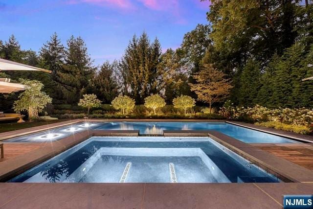 354 Hardenburgh Ave, Demarest, NJ 07627 - pool at dusk featuring an outdoor pool and an in-ground hot tub