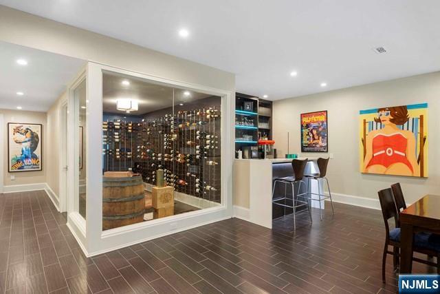 354 Hardenburgh Ave, Demarest, NJ 07627 - wine cellar featuring recessed lighting, wood finished floors, baseboards, and a community bar