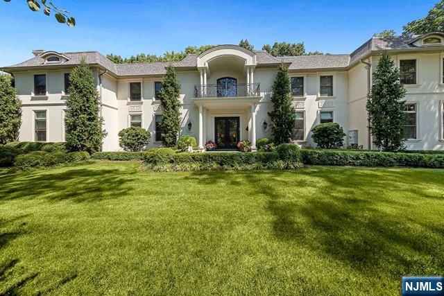 354 Hardenburgh Ave, Demarest, NJ 07627 - view of front of house featuring stucco siding, a front yard, and a balcony