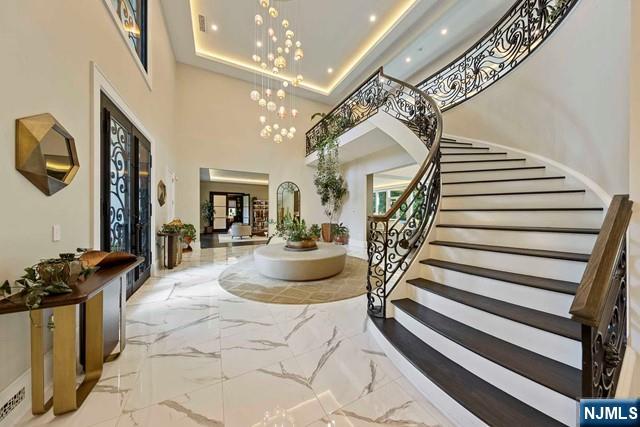 354 Hardenburgh Ave, Demarest, NJ 07627 - foyer with marble tiled floors, a towering ceiling, stairs, recessed lighting, and a chandelier