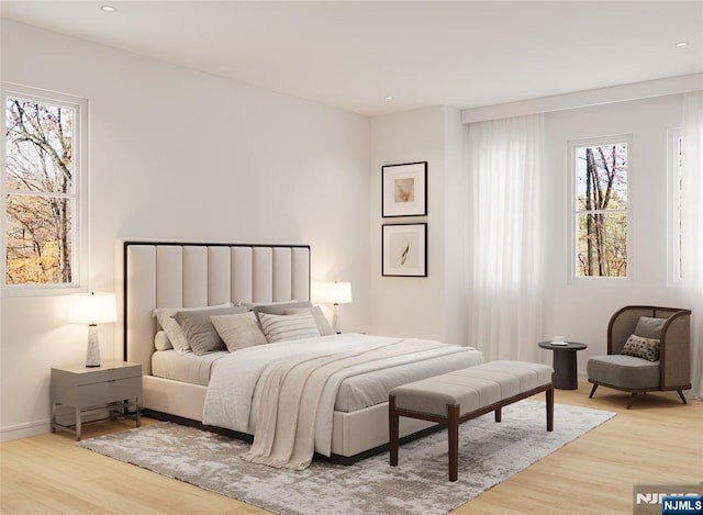 bedroom with baseboards, multiple windows, recessed lighting, and wood finished floors