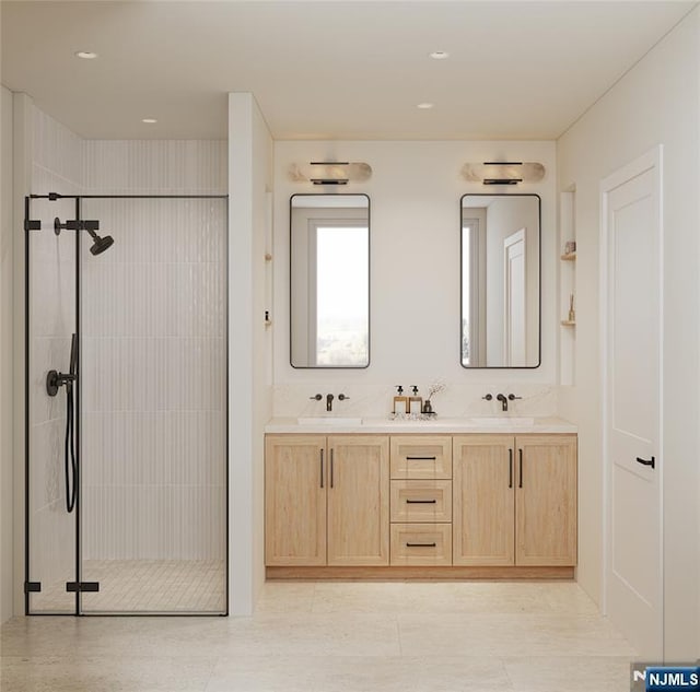 bathroom featuring double vanity, a sink, and a stall shower