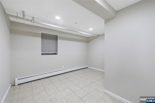 finished basement featuring tile patterned floors, baseboards, recessed lighting, and a baseboard radiator