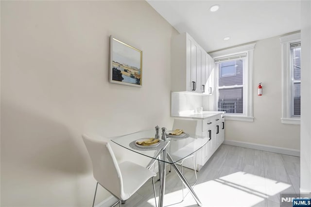 dining area with baseboards and recessed lighting