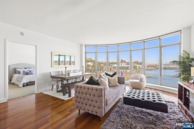 8100 River Rd Unit 1013, North Bergen, NJ 07047 - living area with wood finished floors, healthy amount of natural light, a wall of windows, and a water view