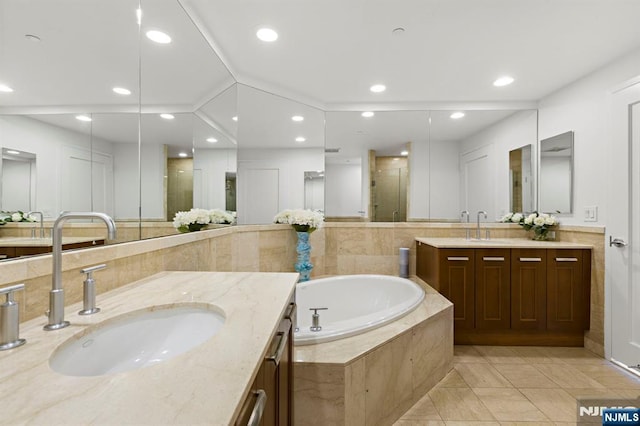 8100 River Rd Unit 1013, North Bergen, NJ 07047 - full bathroom with two vanities, a shower stall, a garden tub, and recessed lighting