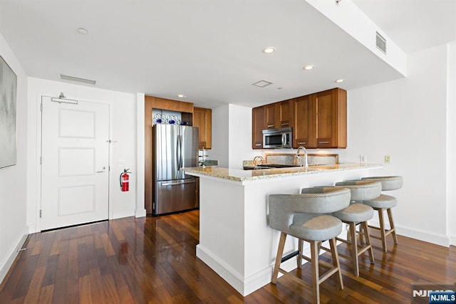 8100 River Rd Unit 1013, North Bergen, NJ 07047 - kitchen featuring appliances with stainless steel finishes, a peninsula, baseboards, dark wood-style flooring, and recessed lighting