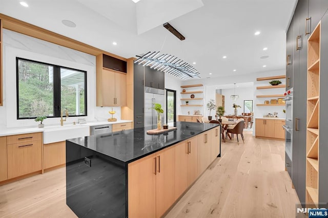 kitchen featuring open shelves, modern cabinets, and a sink