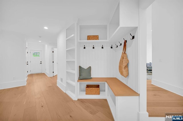 mudroom featuring built in shelves, baseboards, light wood finished floors, and recessed lighting