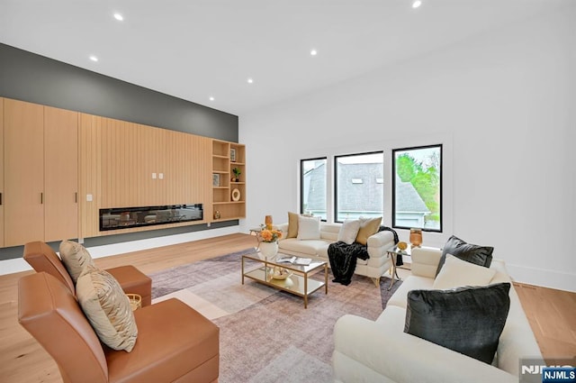living area with recessed lighting and light wood-type flooring
