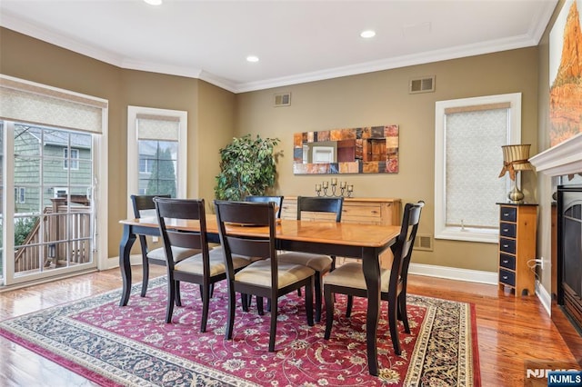 dining area featuring baseboards, ornamental molding, and visible vents