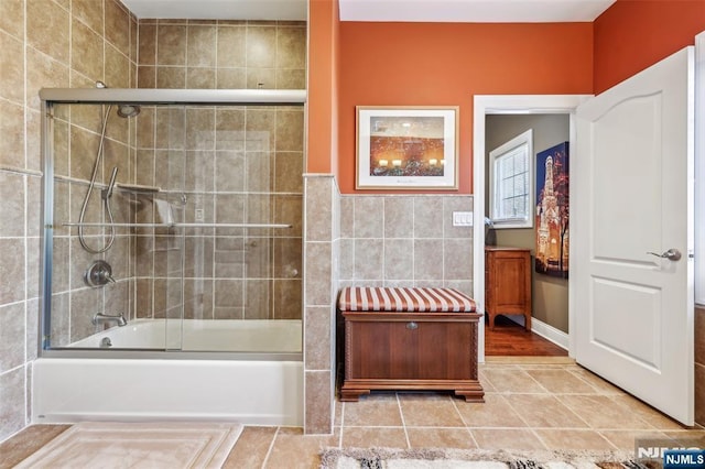 full bathroom featuring tile patterned floors and shower / bath combination with glass door