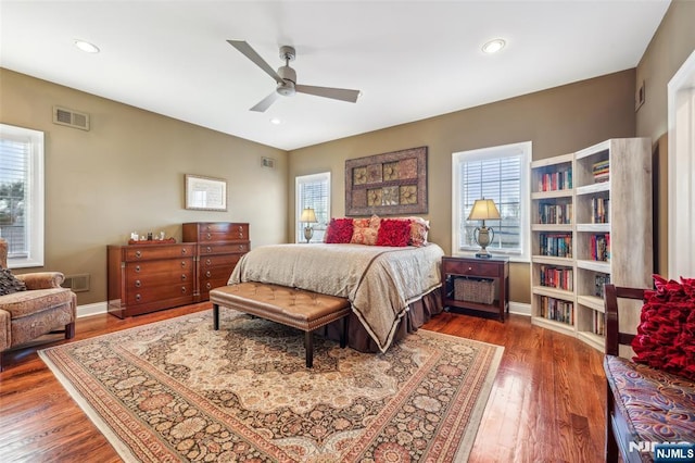 bedroom with wood finished floors, multiple windows, and visible vents
