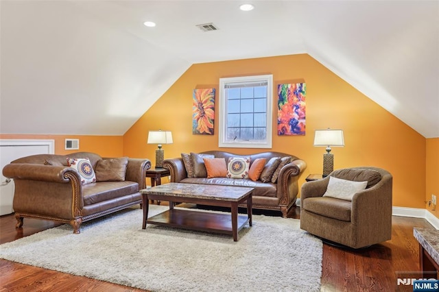living area with recessed lighting, vaulted ceiling, wood finished floors, and visible vents
