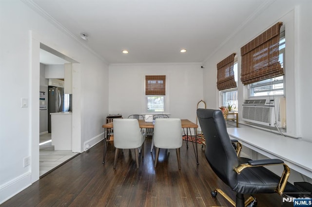 dining space featuring crown molding, wood-type flooring, and plenty of natural light