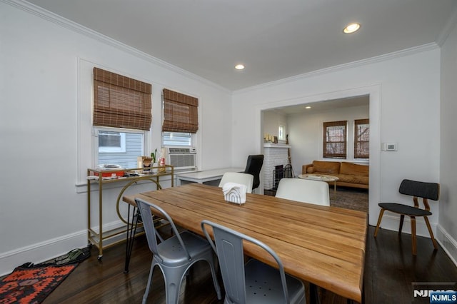 dining space featuring dark wood-type flooring, cooling unit, ornamental molding, and baseboards
