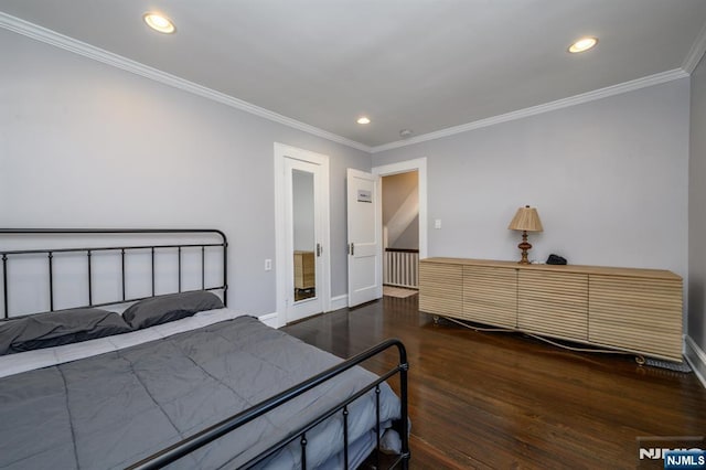 bedroom with ornamental molding, recessed lighting, wood finished floors, and baseboards