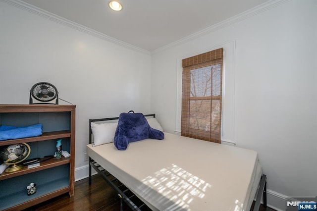 bedroom with crown molding, dark wood finished floors, and baseboards