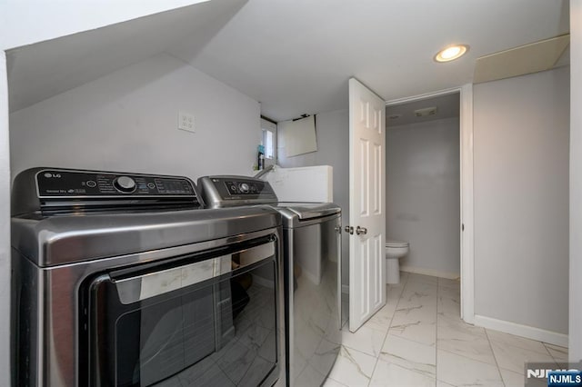 washroom with recessed lighting, laundry area, washing machine and clothes dryer, marble finish floor, and baseboards