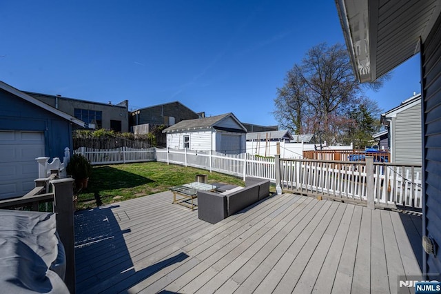 wooden deck featuring a yard, a residential view, and a fenced backyard